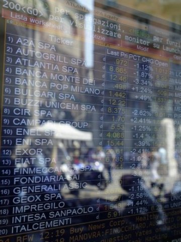 <p>
	Отражения в електронно табло с борсови котировки пред банка в Милано. <em>Снимка: Ройтерс</em></p>
