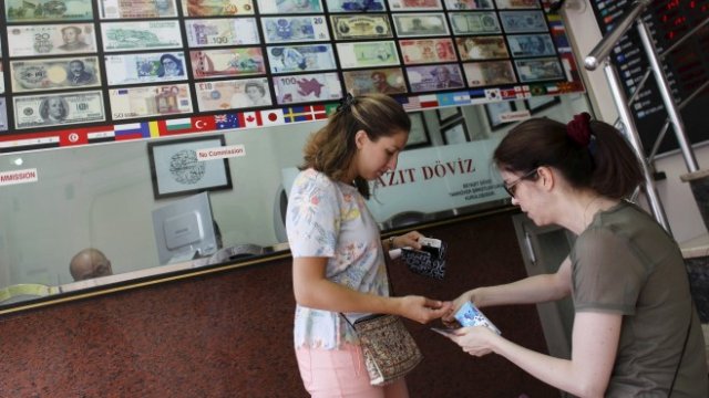 <p>
	Чуждестранен турист брои парите си в чейндж бюро в турската столица. <em>Снимка: Ройтерс</em></p>
