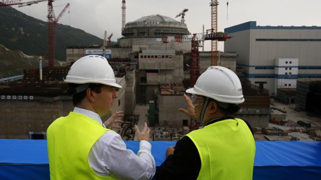 <p>
	Финансовият министър на Великобритания Джордж Осбърн разговаря с представител на китайския собственик на централата в Тайшан, Снимка: <em>Ройтерс</em></p>
