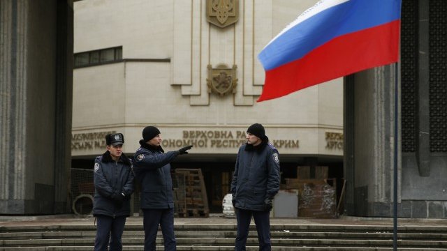 <p>
	Пред местния парламент на&nbsp;Симферопол вече се вее руското знаме. <em>Снимка: Ройтерс</em></p>
