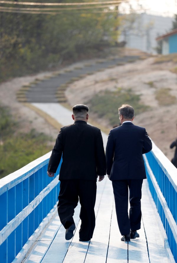 
	Двамата лидери вървят заедно към село в демитализираната зона.

	Снимка: Ройтерс
