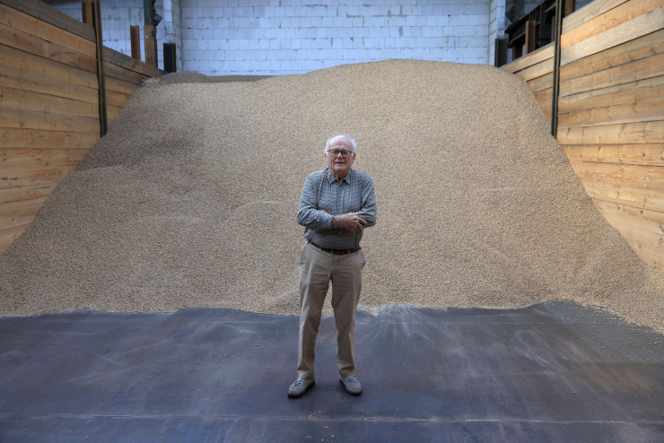 Петер Енгелке стои до куп пелети в склада на компанията си в Берлин. Снимка: Krisztian Bocsi/Bloomberg