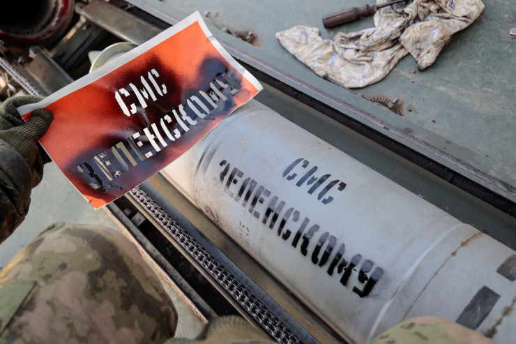 Силите на самопровъзгласилата се Донецка народна република изписват със спрей съобщението „SMS за Зеленски“ върху ракетата, докато се готвят да стрелят със самоходна минохвъргачка 2С4 „Лале“ недалеч от Бахмут, Донецка област. Снимка: EPA/ALESSANDRO GUERRA